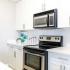 kitchen with all white cabinetry and stainless appliance package