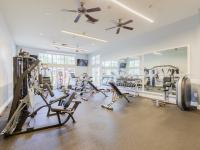 Fitness center with treadmills, elliptical, weight machines, and medicine balls