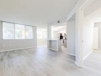 Newly renovated open concept living room and dining room, large kitchen with light sand plank flooring thoughout