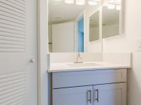 Newly renovated bathrooms with white/gray wood shaker style cabinetry