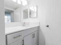 Newly renovated bathrooms with upgraded light fixtures and shaker style cabinetry
