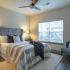 Three-Bedroom Apartments in West Nashville TN - Summit at Nashville West Apartments - Bedroom with Wood-style Flooring, Large Window, and Ceiling Fan