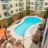Apartments in Germantown Nashville for Rent-909 Flats-Gated Pool with Lounge Seating, Umbrellas, and Tables