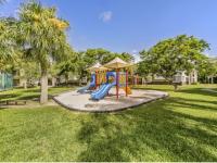 Colorful community playground and park area with bench