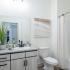 The Crockett - Modern Bathroom with Shower/Tub Combo, Large Vanity, and Modern Light Fixtures.