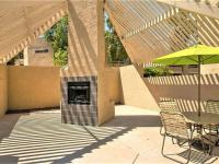 patio table and outdoor fireplace under poolside cabana at silver creek