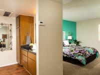 bedroom with green accent wall and furnished with bed and nightstands at metro on main