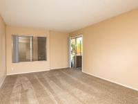 living room with brown carpet and sliding door to patio at Copper Canyon