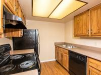 galley kitchen with black appliances and wood cabinets at Copper Canyon