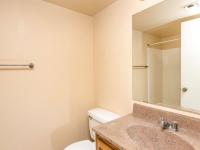full bath with shower tub combo with sliding door and brown vanity at Copper Canyon