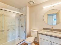 full bath with sliding glass door shower and granite vanity at redfield ridge apartments