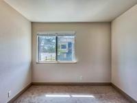 Bedroom with window and brown carpet at redfield ridge apartments