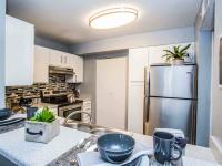 kitchen with stainless steel appliances and breakfast bar at the cove apartments