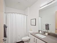 full bath with shower-tub combo and quartz vanity at oro apartments