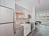 kitchen with stainless steel appliances and white cabinets at oro apartments