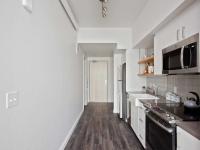 kitchen with stainless steel appliances and white cabinets at oro apartments