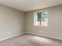 Large Bedroom with Window and Carpet