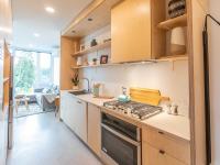 galley kitchen with birch wood cabinets at artisan