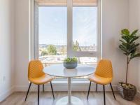dining area with round table and two yellow chairs at Abernethy Flats