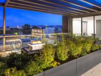 rooftop lounge with decorative plants and fire pit at parallax apartments
