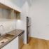 Kitchen with stainless steel dishwasher, refridgerator and white cabinets