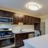 Kitchen with stainless steel appliances at Harvard Village Apartments in Adams Morgan