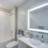 LED backlit mirror above bathroom vanity.
