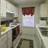 Refrigerator, counters, cabinets, stove, microwave, and sink in a kitchen at Cayce Cove