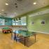 Ping-pong table and pool table in game room at The Landings at Chandler Crossings | Off-Campus Housing Near MSU