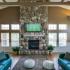 Comfortable seating in lounge area for flat screen TV above fireplace at The Landings at Chandler Crossings | Off-Campus Housing Near MSU