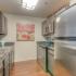 Stainless steal appliances in galley-style kitchen at apartment at The Landings at Chandler Crossings | East Lansing MSU Off-Campus Apartments.