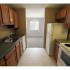 Long Pond Village Apartments, interior, galley kitchen, white appliances, refrigerator, stove/oven, tan cabinets, green counters, tiled floor, view to dining room, window