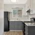 kitchen with black appliances and grey and white cabinets