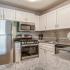 kitchen with stainless steel appliances and white cabinets