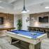 Game room with pool table, shuffleboard, and seating
