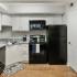 Kitchen with black appliances and white cabinets