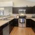 Kitchen with stainless steel appliances and dark brown cabinets