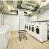Arabella 101, interior, laundry facility, cart, white washers and dryers, tile floor, vent ducts