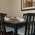 Dining area with black dining table and four chairs at The Commons at Fallsington apartments for rent