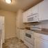 Coryell Crossing Apartments kitchen with white cabinets, white appliances and laminate floors