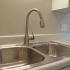 Photo of New sink and kitchen appliances in remodeled one bedroom