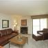 Living room with fireplace and sliding door to balcony |Westchester Park Manhattan, KS apartments One Bedroom