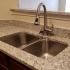 Close up of sink & counter in modern kitchen | Apartments In Overland Park Kansas | The Woods of Cherry Creek Apartments