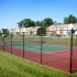 tennis court and apartment buildings on sunny day