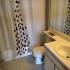 La Vue at Emerald Pointe, bathroom, sink, vanity mirror, toilet, shower curtain, tile flooring, cabinets
