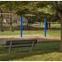 Playground and bench in wooded area at Piney Ridge Apartments & Townhomes.