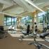 Block75 Apartments, interior, fitness center, large windows, weight machines, hand weights, high ceilings.
