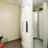 Block75 Apartments, interior, upright tanning stall, clear chair, carpet