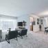 Fallstaff Manor Apts, interior, living room, dining room, plush wall to wall carpet, walkout patio, sofa, two chairs, 2 ottomans, large coffee table, TV console, round dining table, 4 chairs