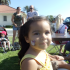 A young child with face paint on her cheek smiles at the camera. Various other people can be seen in the background talking and sitting around tables.  | Houses for rent, Los Angeles AFB